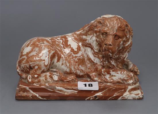 A 19th century agateware model of a recumbent lion length 19cm